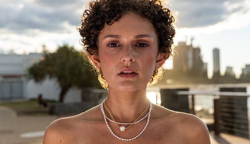 Woman wearing The Loop Store gold chain necklace, lifestyle shoot Gold Coast